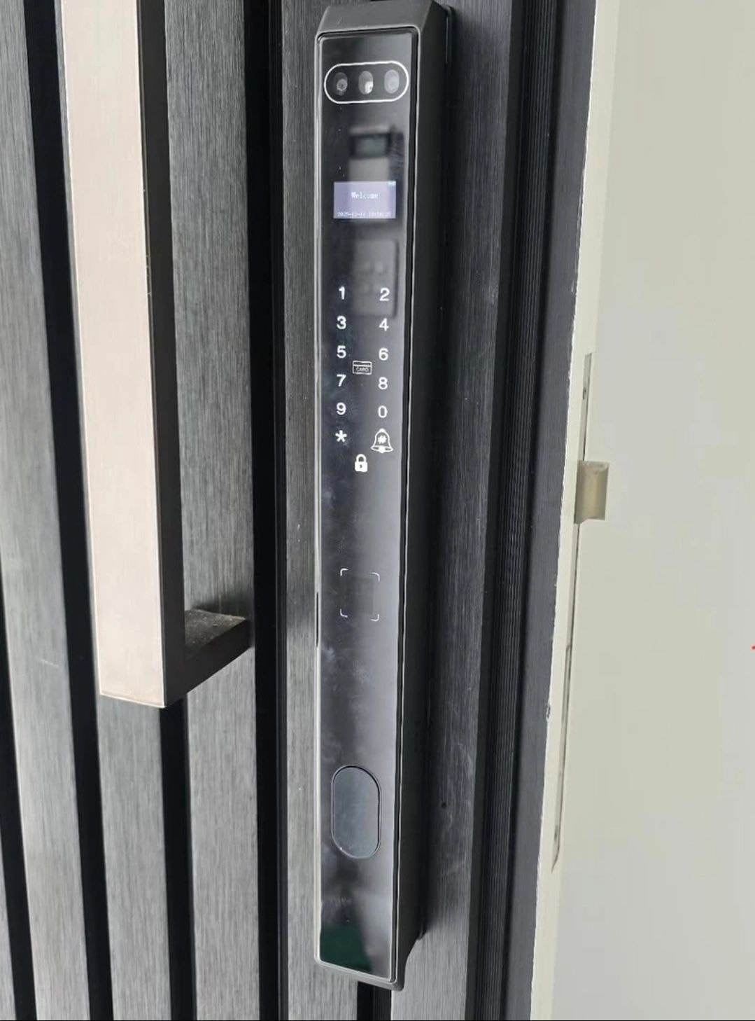 Trojan smart lock with display screen mounted on dark wood door — Rhodes Locksmiths