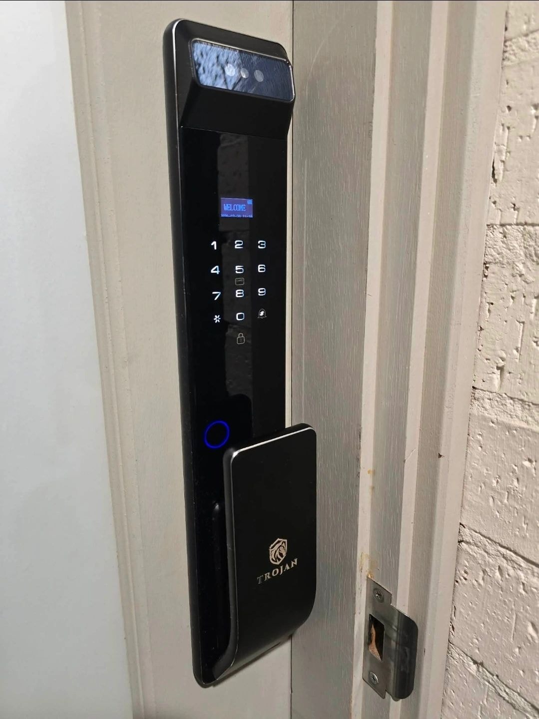 Trojan smart lock with fingerprint sensor on white door — Rhodes NSW